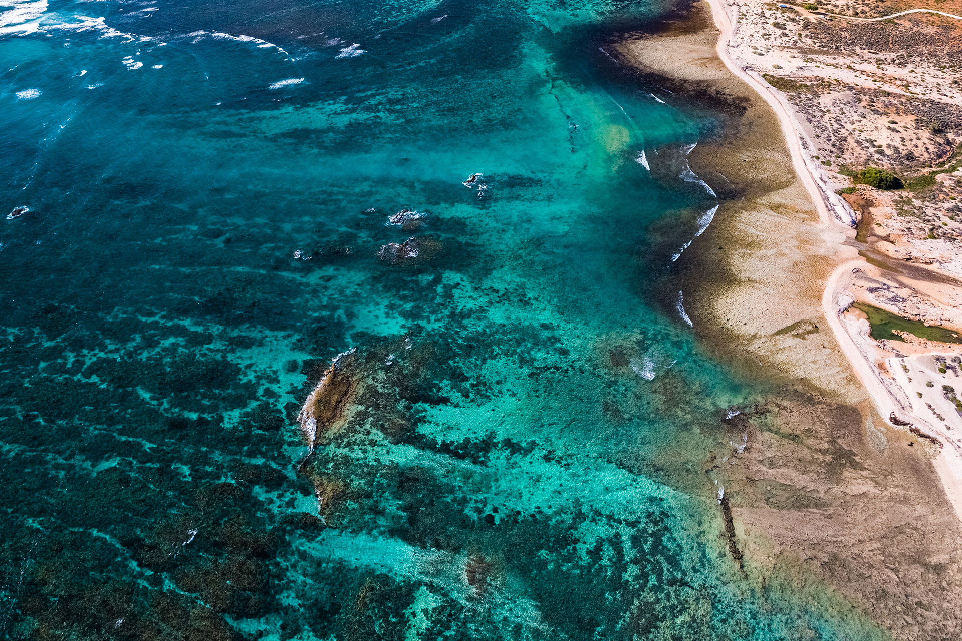 Get a bird’s eye view of the world-famous Ningaloo Reef by booking a flight in a microlight aircraft. Photo credit: Tourism Western Australia