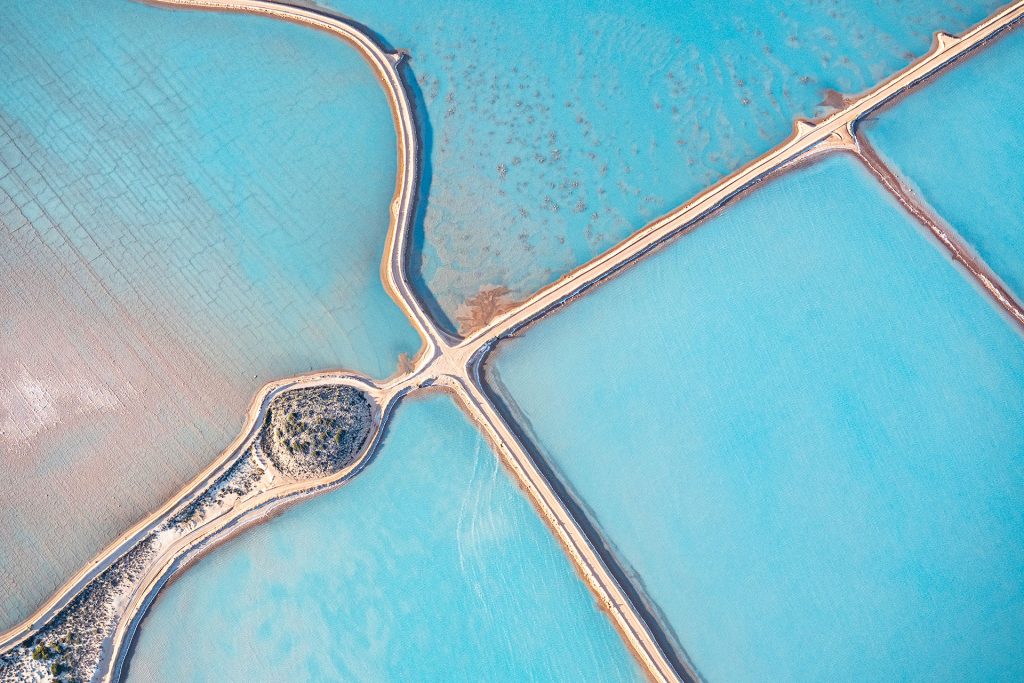Aerial photo taken from a small plane showing a patchwork quilt of the salt works below at Useless Loop, Shark Bay, Western Australia.
